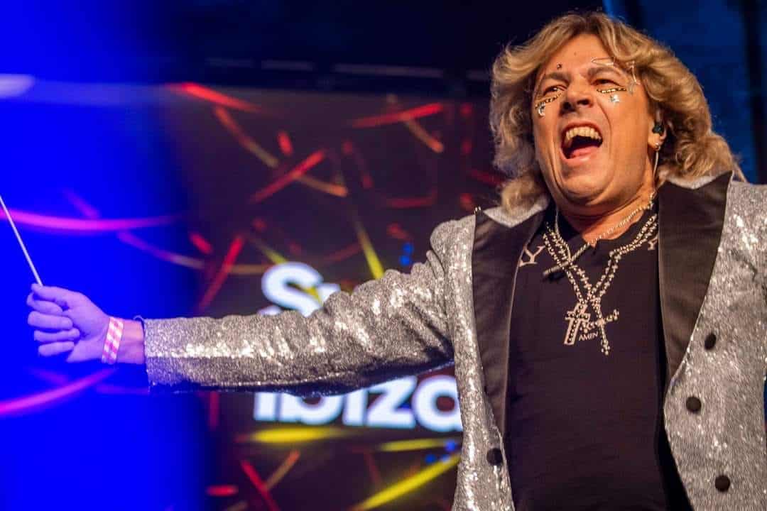 Symphonic Ibiza conductor performing with Ibiza branding on the stage screen